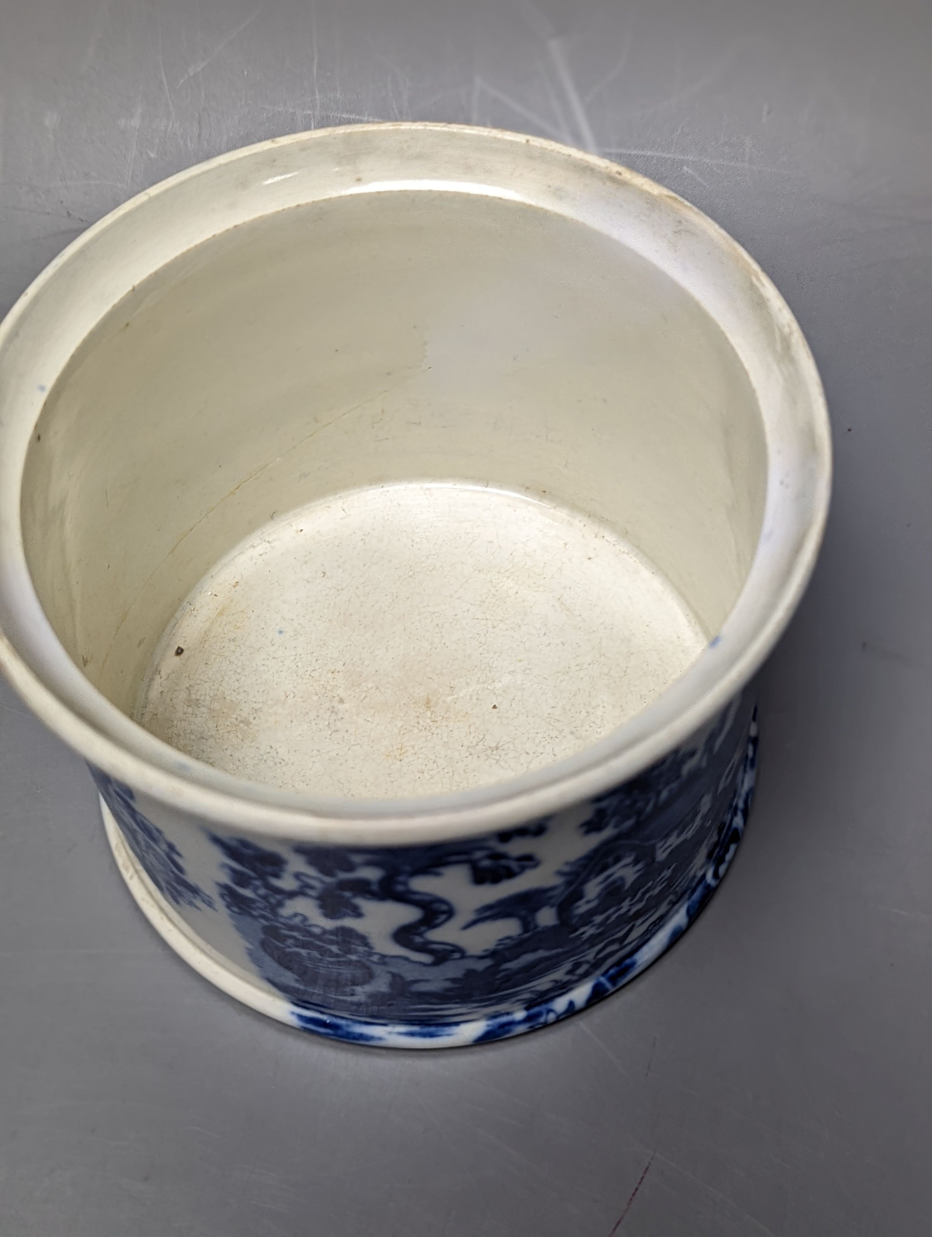 Four items of early 19th century blue and white pearlware pottery, an 18th century Delft blue and white vase and a 19th century toothbrush holder, Delft vase 22 cms high.